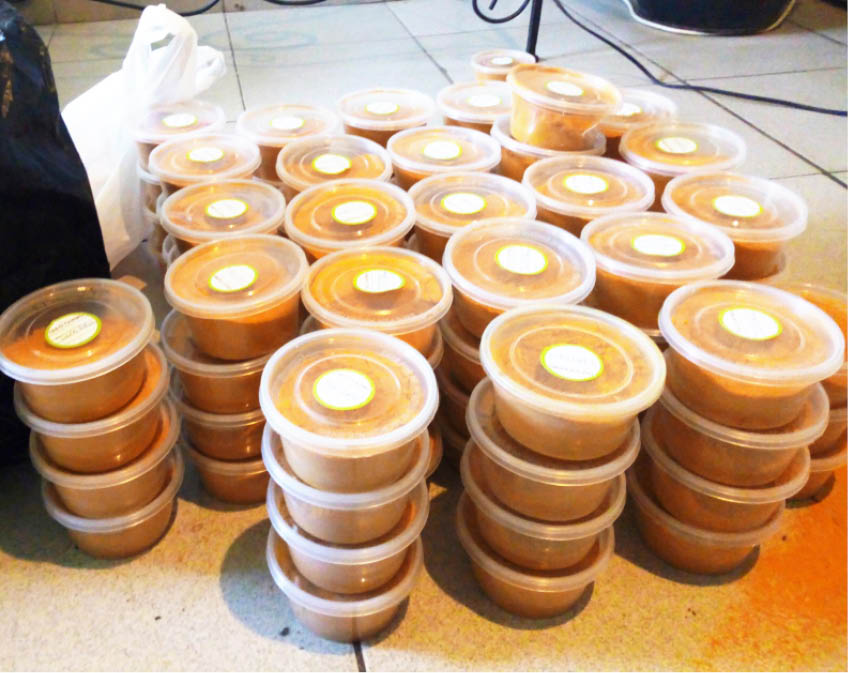 Mrs Jibrin (insert) arranges her processed Turmeric